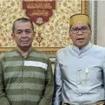 two men standing next to each other